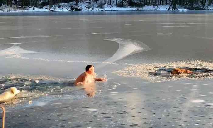 Timofey Yuriev et sa Golden Retriever Kira dans l'eau gelée du lac